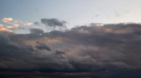 Dark rain clouds in the evening sky, timelapse. Dramatic sky with an coming c Stock Photos