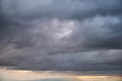 Dark rain clouds in the evening sky. Dramatic sky with an coming cloudy cyclo Stock Photos