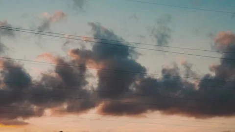 Dark rain clouds moving fast in warm summer evening sunset in time lapse Stock Footage 163185498