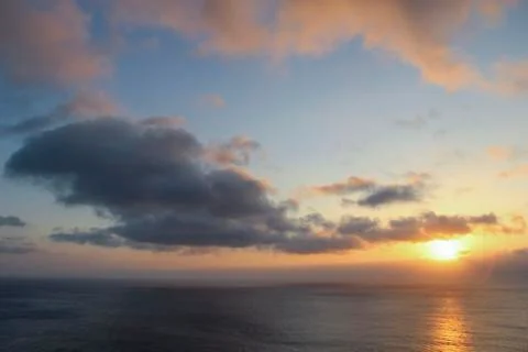 Dark rainy cloudscape at sunset with sunrays through the clouds Stock-Fotos
