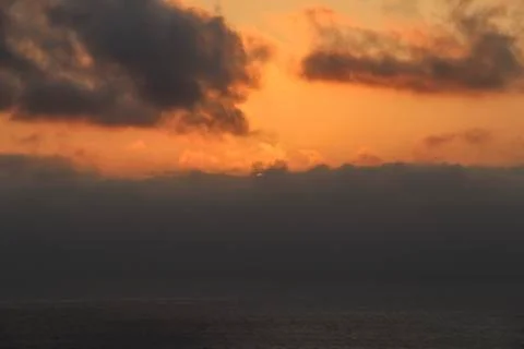 Dark rainy cloudscape at sunset with sunrays through the clouds Stock-Fotos