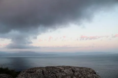 Dark rainy cloudscape at sunset with sunrays through the clouds Stock-Fotos