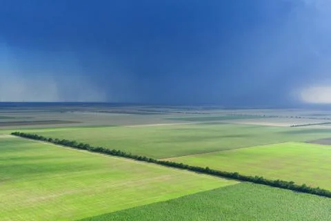Dark rainy sky and dramatic black clouds being raining. Big rain storm and fi Stock Photos