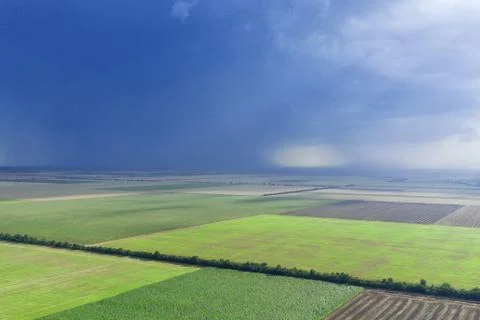 Dark rainy sky and dramatic black clouds being raining. Big rain storm and fi Stock Photos