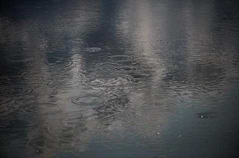 Dark Rainy Water Surface With Deep Ripples Stock Photos