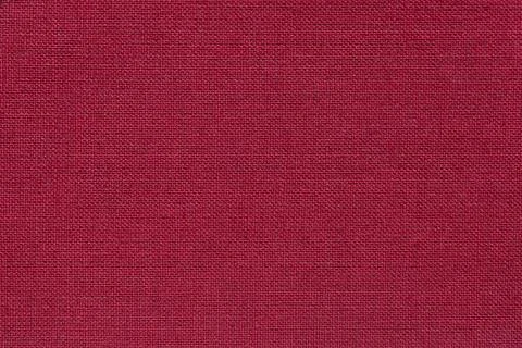 Dark red background from a textile material with wicker pattern, closeup. Foto stock