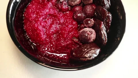 Dark red beetroot puree, blueberries, prunes, and cranberries. Stock Footage 336677864