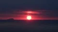 Dark red burning sky with sun hiding down over horizon, darkness falls, sunset HD Footage