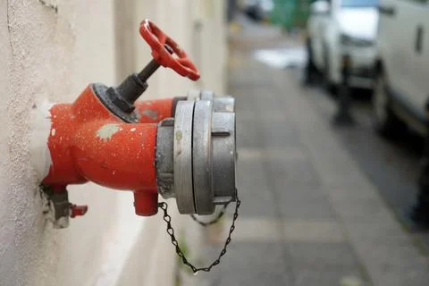 A Dark Red Fire Hydrant Sits Inside An Old Wall Stock Photos