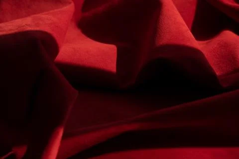 Dark red matte background of suede fabric, closeup. Velvet texture of seamles Foto stock