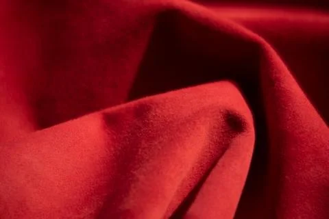 Dark red matte background of suede fabric, closeup. Velvet texture of seamles Foto stock