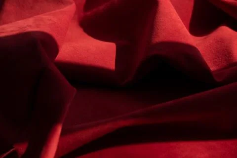 Dark red matte background of suede fabric, closeup. Velvet texture of seamles Foto stock