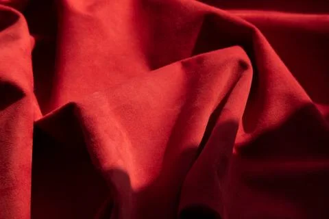 Dark red matte background of suede fabric, closeup. Velvet texture of seamles 스톡 사진