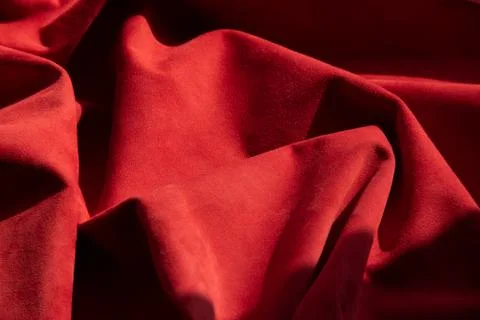 Dark red matte background of suede fabric, closeup. Velvet texture of seamles Foto stock