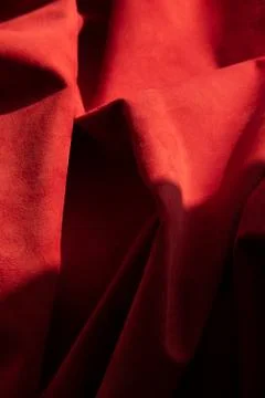 Dark red matte background of suede fabric, closeup. Velvet texture of seamles Foto stock