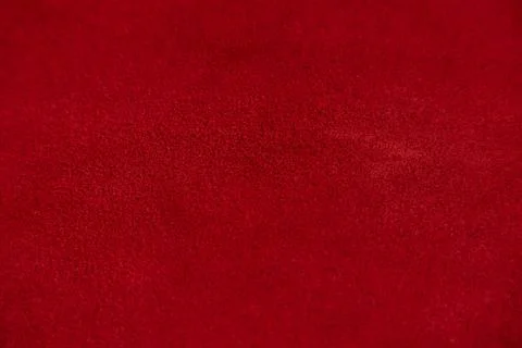 Dark red matte background of suede fabric, closeup. Velvet texture of seamles Foto stock