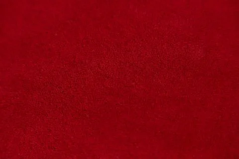 Dark red matte background of suede fabric, closeup. Velvet texture of seamles Stock Photos