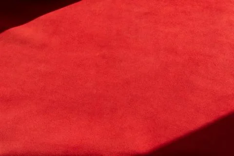 Dark red matte background of suede fabric, closeup. Velvet texture of seamles 스톡 사진
