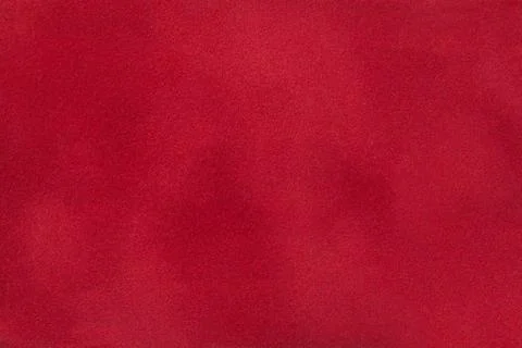 Dark red matte background of suede fabric, closeup. Stock Photos