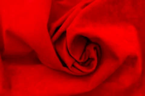 Dark red matte background of suede fabric, closeup. Velvet texture of seamles Stockfoto's