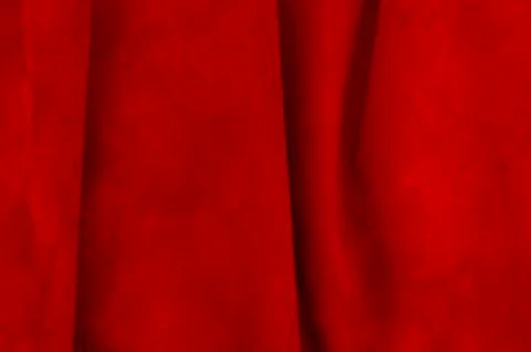 Dark red matte background of suede fabric, closeup. Velvet texture of seamles Stockfoto's