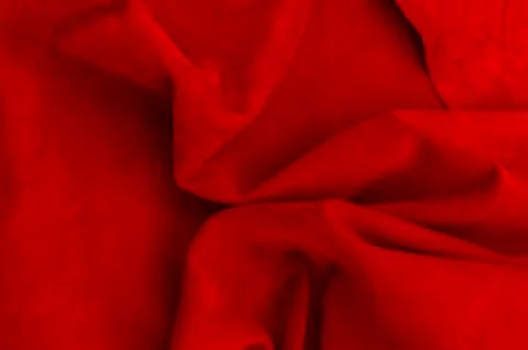 Dark red matte background of suede fabric, closeup. Velvet texture of seamles Foto stock