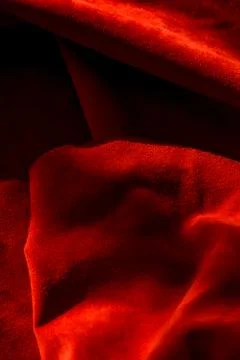 Dark red matte background of suede fabric, closeup. Velvet texture of seamles Stock Photos