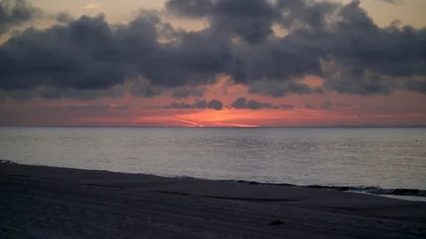 Dark red ocean beach sunset over Gulf of Mexico sea Stock Footage 120270889