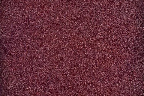 The dark red or maroon wall with ragged texture Stock Photos
