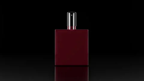 Dark Red Perfume Bottle on Black Reflective Surface Showcasing Minimalist Design Stock Footage 316680697