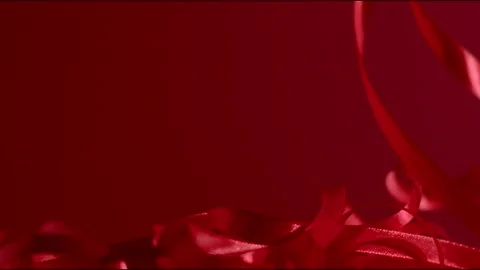 Dark red silky ribbon falling down on a granate backdrop. Full hd still shot Stock Footage 146167970