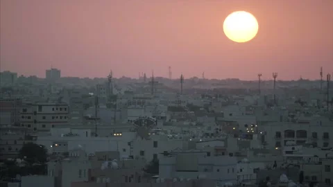 Dark red sun sets over the middle eastern skyline. Stock Footage 157396744