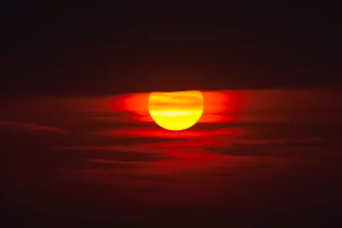 A dark red sunset with cloud layers Stock Photos