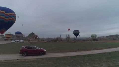 Dark red SUV flying through hot air baloons, jb01 Stock Footage 105022504