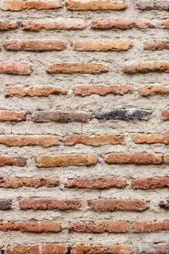 A dark red texture from an old brick wall. A destructive destruction of a bri Stock Photos