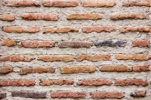 A dark red texture from an old brick wall. A destructive destruction of a bri Stock Photos