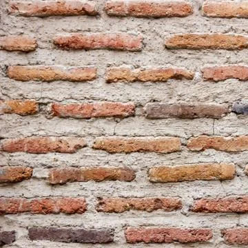 A dark red texture from an old brick wall. A destructive destruction of a bri Foto stock