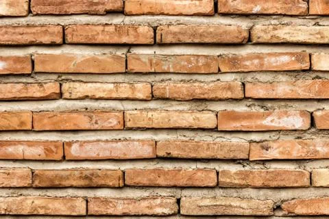 A dark red texture from an old brick wall. A destructive destruction of a bri Stock Photos