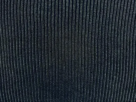 Dark ribbed knit fabric texture with vertical ridges intricate stitches and c Stock Photos