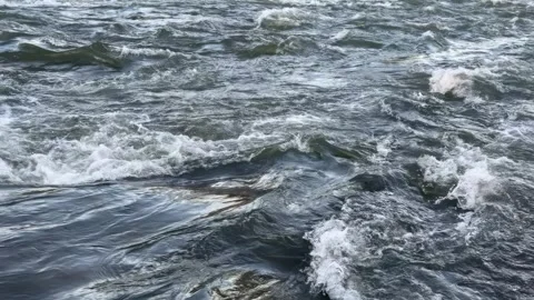Dark River Water Rushes Over Rocks in a Fast Flowing Current in slow-motion Stock Footage 301004858