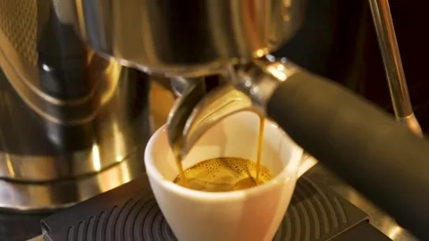 Dark Roast Espresso Extraction with Rich Golden Crema at Professional Cafe Bar Stock Footage 336034228