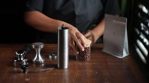 Dark roasted bean poured by home barist Stock Footage 203770297