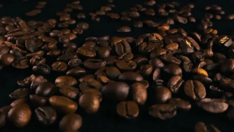 Dark roasted coffee beans on a black background Stock Footage 340140745