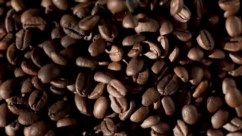 Dark roasted coffee beans falling, showcasing vibrant texture and aroma of Video stock 277015165