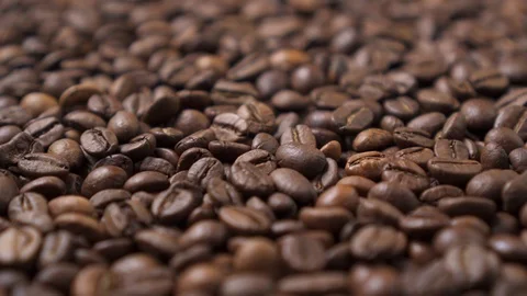 Dark roasted coffee beans move in a circle. Stock Footage 124493115