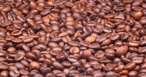 Dark roasted coffee beans on a turntable in C4K resolution Видео 99331144