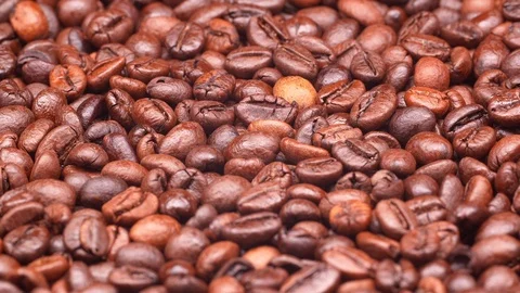 Dark roasted coffee beans on a turntable in UHD Stock-Footage 99331362