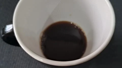 Dark roasted coffee inside white ceramic mug motion video clip Video stock 339249044