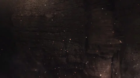 Dark Rock Wall Background with Floating Embers and Dust Particles Loop Stock Footage 340375266