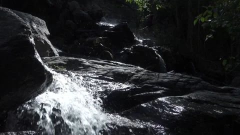 Dark Rocks With Small Waterfalls Flowing Through Them Stock Footage 232050282